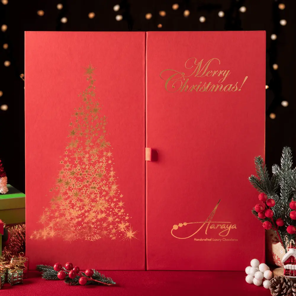 Decadent Santa and Christmas tree made from premium chocolate, adorned with festive chocolate balls – Aaraya Chocolatiers' luxurious Christmas hamper, a sensory delight for the holidays.