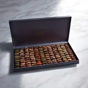 AARAYA® Silver Luxe Assorted Dates Gift Box showcasing an elegant silver box filled with premium gourmet dates and indulgent fillings like pistachio ganache, salted hazelnut, and orange peel.
