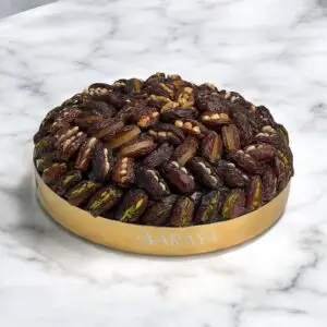 The AARAYA® Luxury Assorted Dates Tray Gilded Majesty is an exquisite 36 cm gilded tray featuring 1.7 kg of hand-picked luxury dates with premium fillings like pistachio ganache, salted hazelnut, and more. Perfect for Ramadan, gifting, or special occasions, this elegant tray combines sophistication and gourmet indulgence. Product Features: Premium Assorted Fillings: Walnut, Lemon Peel, Cashew, Orange Peel, Pistachio, Feuilletine Crunch, Pistachio Ganache, Almond, Salted Hazelnut Tray Dimensions: 36 cm Dates Weight: 1.7 kg Total Weight: 2.6 kg Elegant Design: Encased in a luxurious gilded tray Award-Winning Quality: Great Taste Awards 2022 & 2023 Allergen Information: Contains nuts and dairy. Produced in a facility that handles gluten and soy.