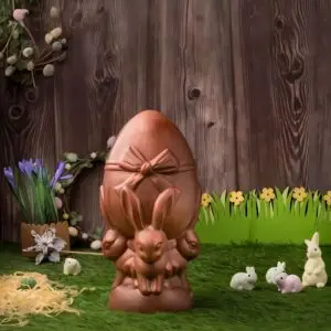 AARAYA® Bunny Embrace Easter Egg 16 CM – a handcrafted premium chocolate egg held by sculpted bunnies, made from fine couverture chocolate. A luxurious Easter centerpiece and gift symbolizing warmth, joy, and artisanal craftsmanship.