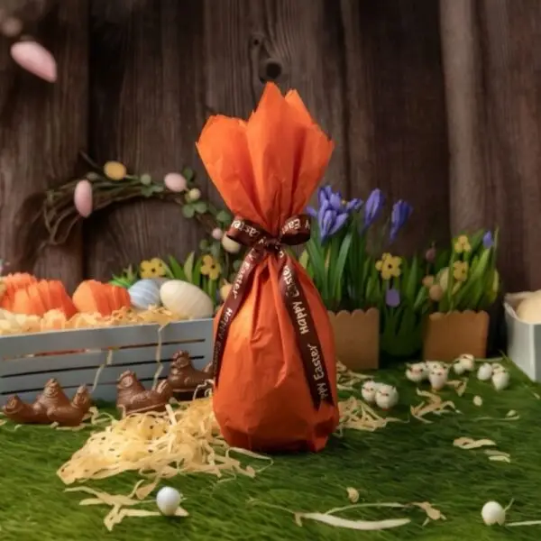 AARAYA® Bunny Embrace Easter Egg 16 CM – a handcrafted premium chocolate egg held by sculpted bunnies, made from fine couverture chocolate. A luxurious Easter centerpiece and gift symbolizing warmth, joy, and artisanal craftsmanship.