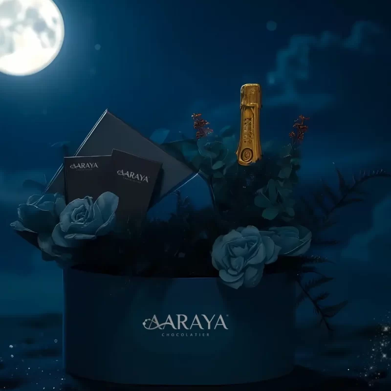 AARAYA® Luxury Celebration Gift Hamper – Midnight Blue Edition featuring signature chocolates, truffle jars, almond dragees, candle, and non-alcoholic champagne in a midnight blue velvet box, perfect for luxury Diwali and corporate gifting in Dubai.