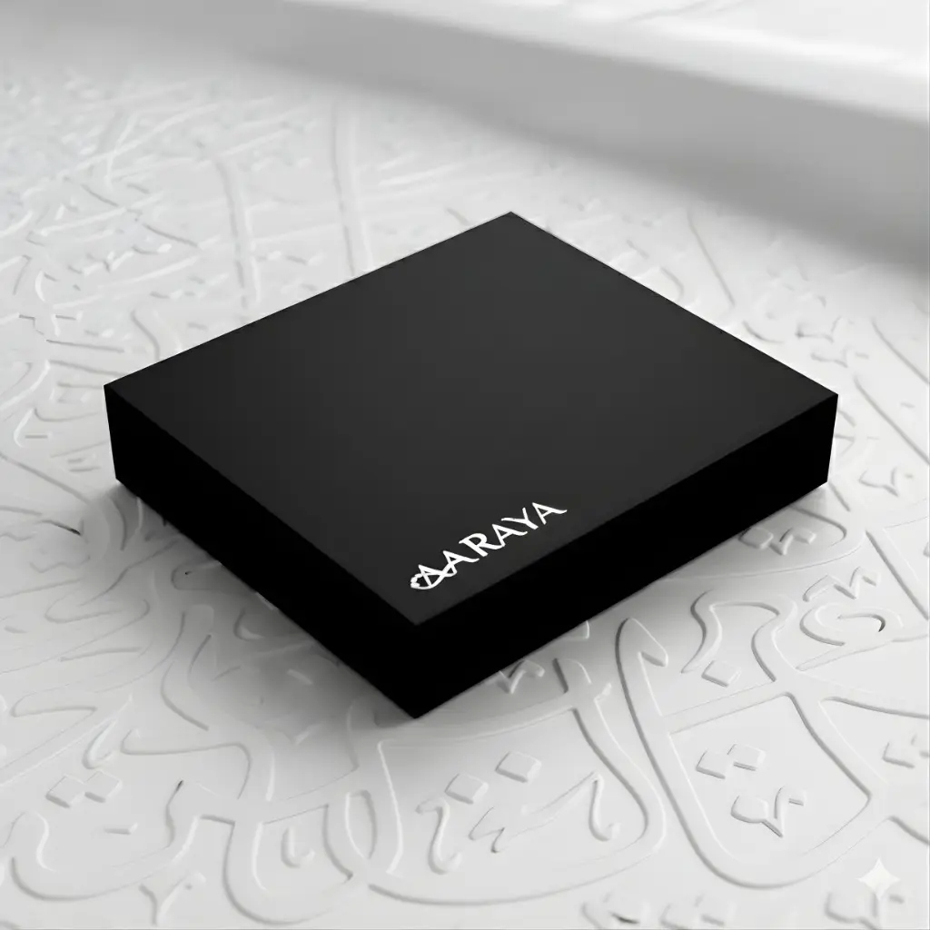 Luxury black compact gift box by AARAYA® containing 25 artisanal chocolates arranged in UAE National Day colours.