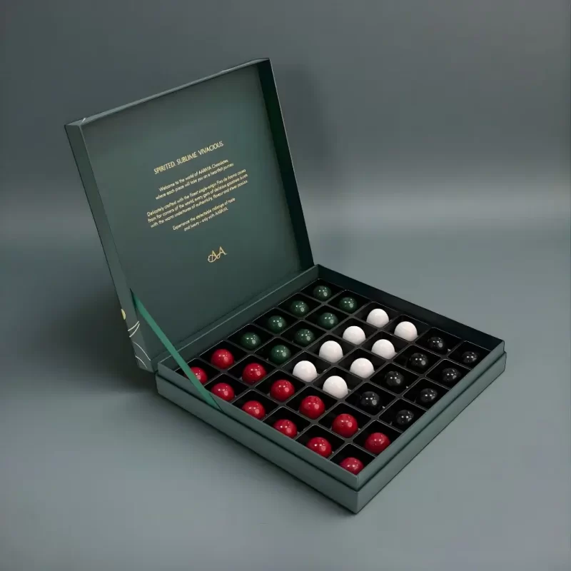 Premium AARAYA® National Day Signature Chocolate box featuring 36 artisanal chocolates arranged in UAE flag colours.