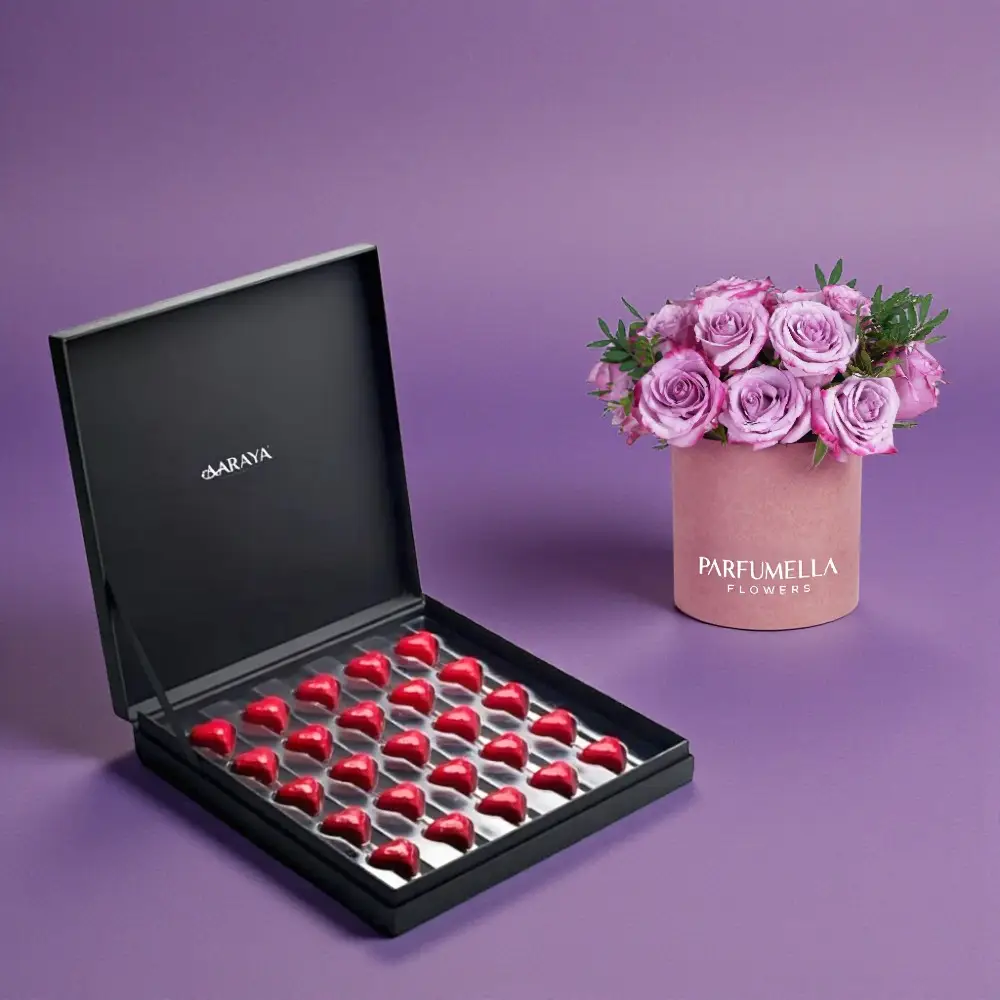 The AARAYA® Premium Valentine’s Chocolate Box with Pink Rose Hatbox is a refined expression of romance, elegance, and artisanal craftsmanship. Curated for those who appreciate understated luxury, this premium Valentine’s gift set brings together handcrafted heart chocolates and a delicate rose hatbox arrangement for a truly memorable gifting experience.