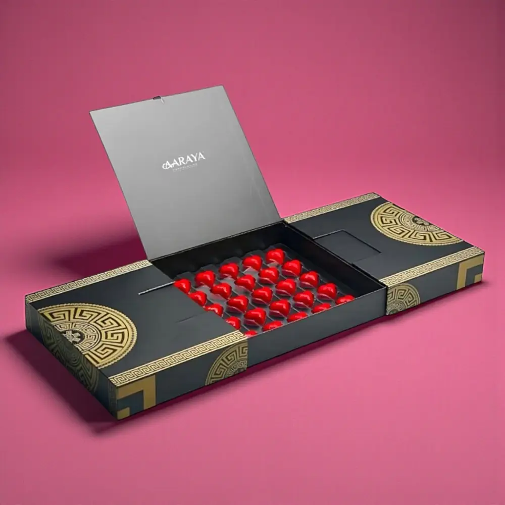 AARAYA® Luxury Noir Valentine’s Heart Chocolates with red heart-shaped chocolates in a black luxury box paired with a romantic red rose bouquet for Valentine’s Day gifting