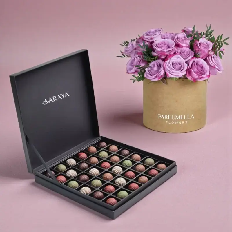 AARAYA Premium Valentine’s Chocolate and Purple Rose Gift Set featuring Midnight Truffle Collection in a luxury black box paired with an elegant purple rose hatbox arrangement.