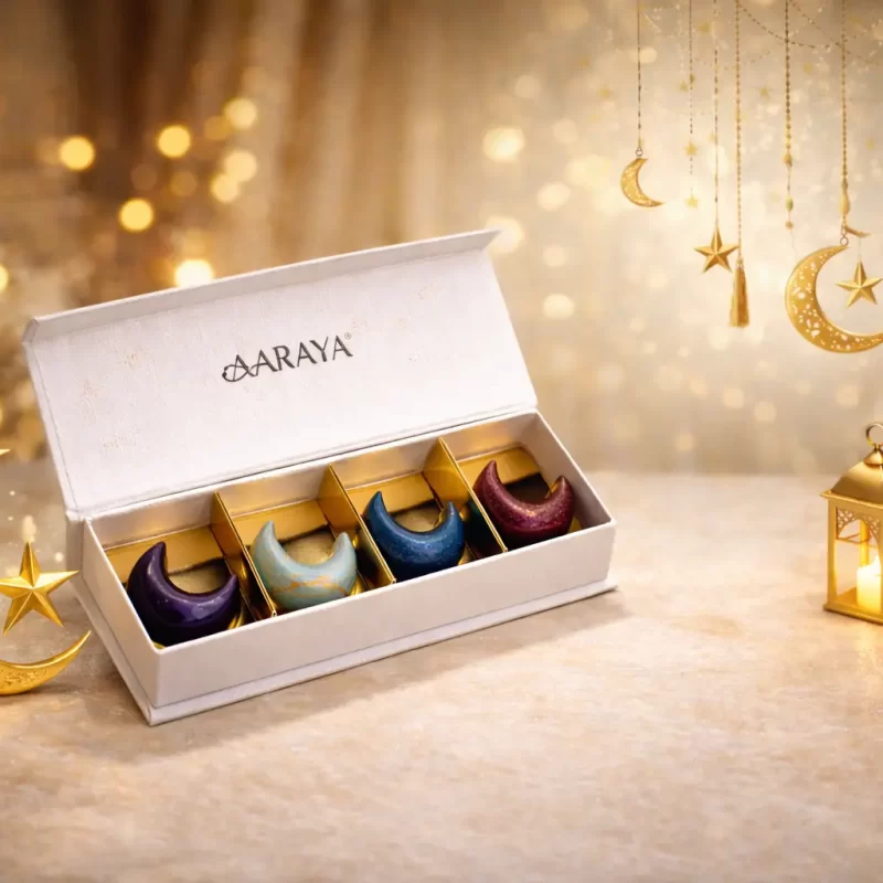 Luxury crescent-shaped Ramadan chocolate gift box by AARAYA® featuring four artisan chocolates in signature gold, white, gradient, and black finishes.