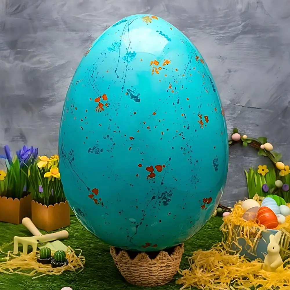 Artisan Luxe Easter Egg by AARAYA®, a 48 cm hand-painted luxury chocolate egg in vibrant turquoise with gold accents, showcased as a premium Easter centerpiece. Crafted by award-winning chocolatiers, perfect for luxury Easter gifting and celebrations in Dubai.