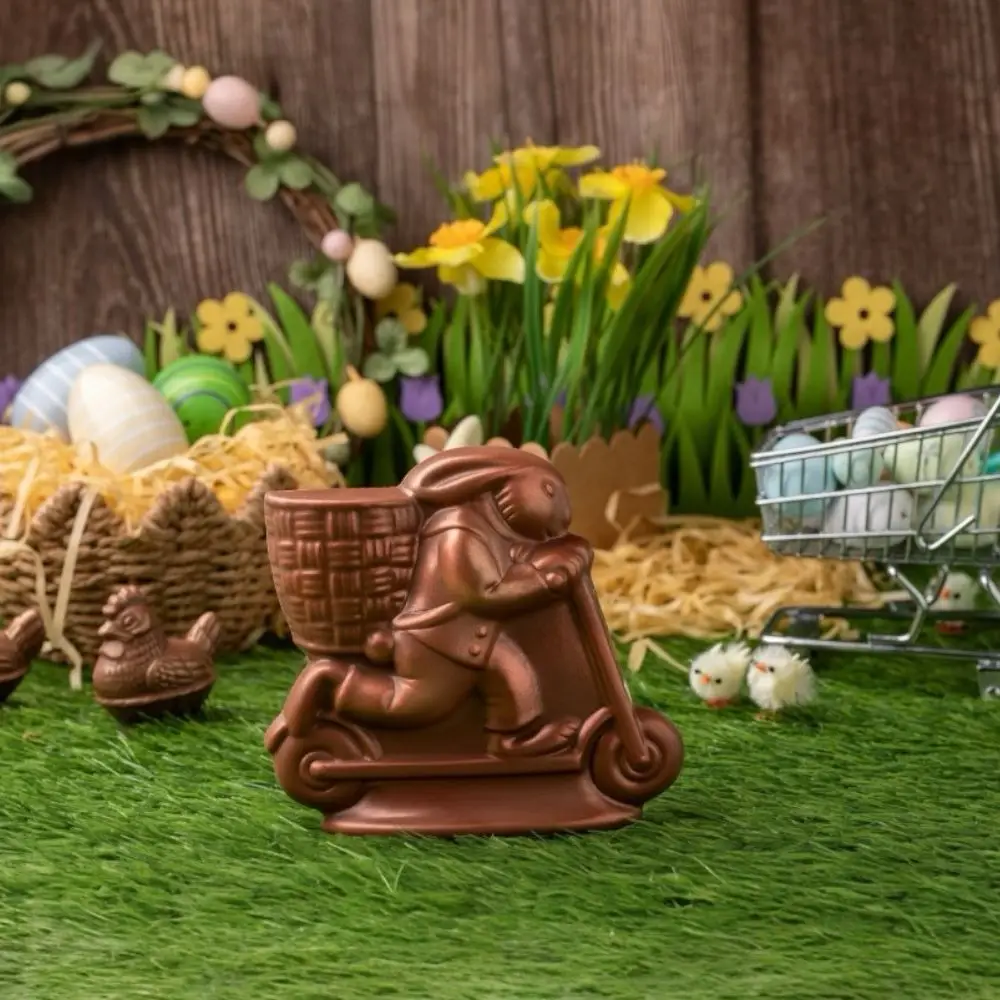 AARAYA® Bunny on a Scooter 12 CM – a handcrafted chocolate sculpture of a lively bunny riding a scooter, made from premium couverture chocolate. A whimsical and luxurious Easter creation.