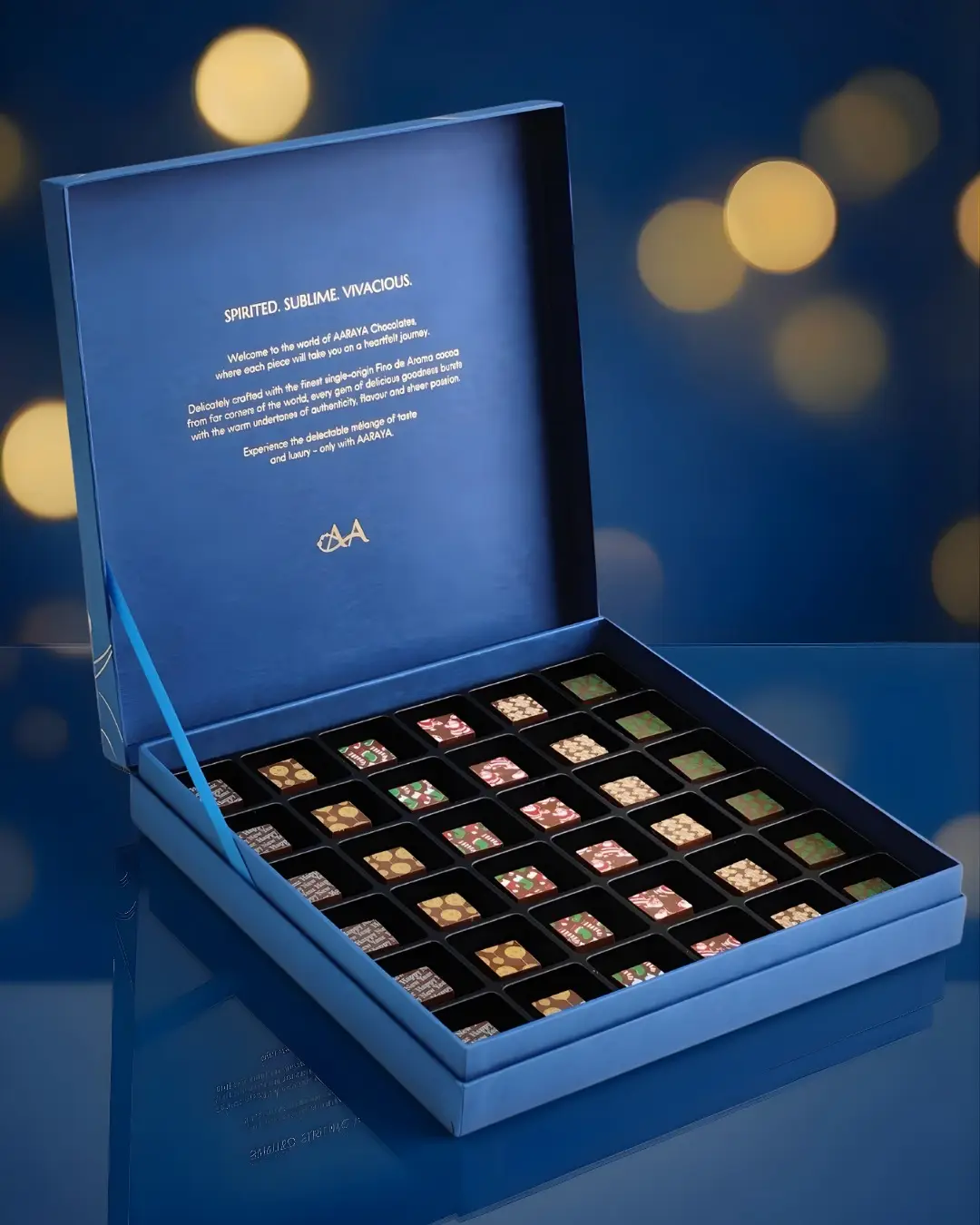 Luxury blue Christmas chocolate gift box by AARAYA® featuring 36 handcrafted festive chocolates arranged in an elegant presentation box